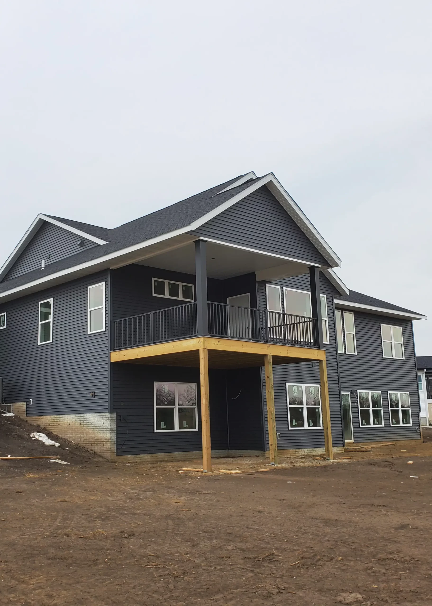 Exterior view of a large-scale white agricultural pole barn with charcoal trim and a reinforced post-frame structure, newly completed by Next-Gen Buildings on a farm property in Assumption, IL